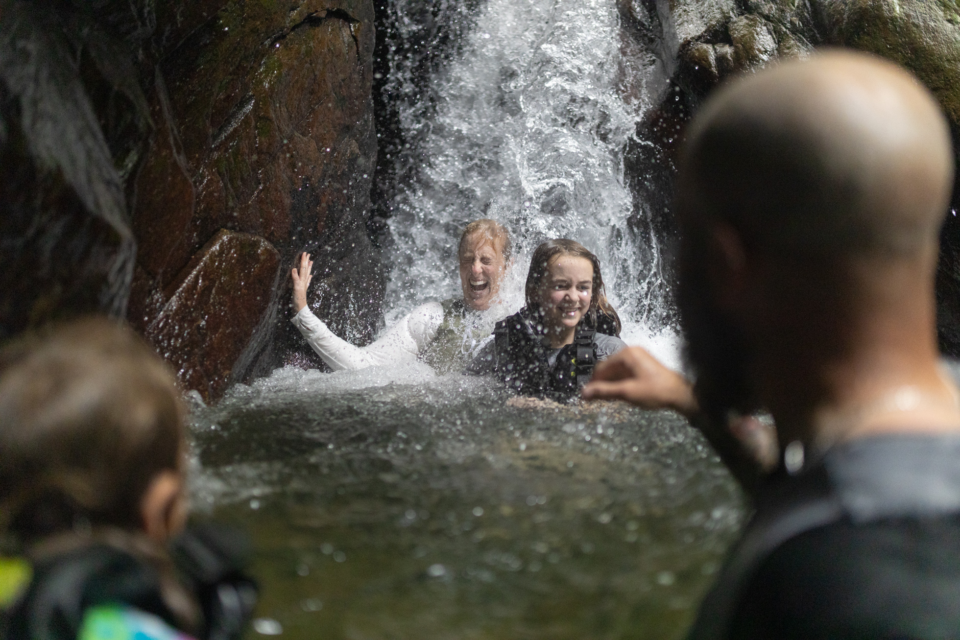 A family enjoying the waterfall pool